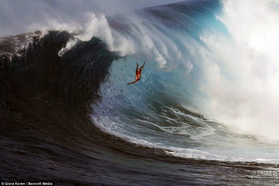 A helpless surfer wipes out on a colossal 12metre-high wave while trying to surf the dangerous wall of water in Maui, Hawaii